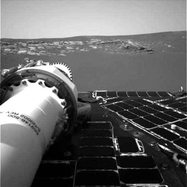 A picture of what appears to be bedrock peaking out from the sands of Mars. Image credit NASA/JPL.